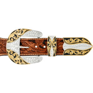 A custom western three piece belt buckle set featuring a silver plated base with golden bronze scrollwork and black enamel